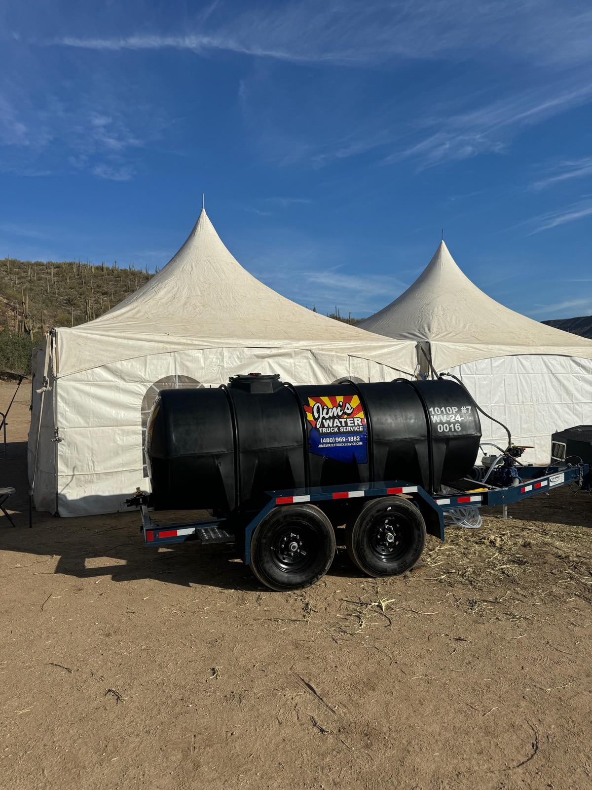 Jim's 1,000-gallon potable water buffalo on-site at an outdoor Arizona event under desert tents.